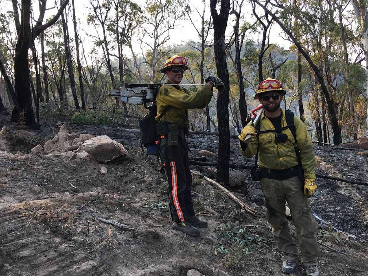 2 firefighters working in fire scene