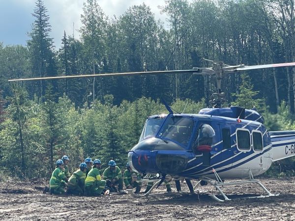 FFMVic firefighters getting ready to jump into a blue helicopter