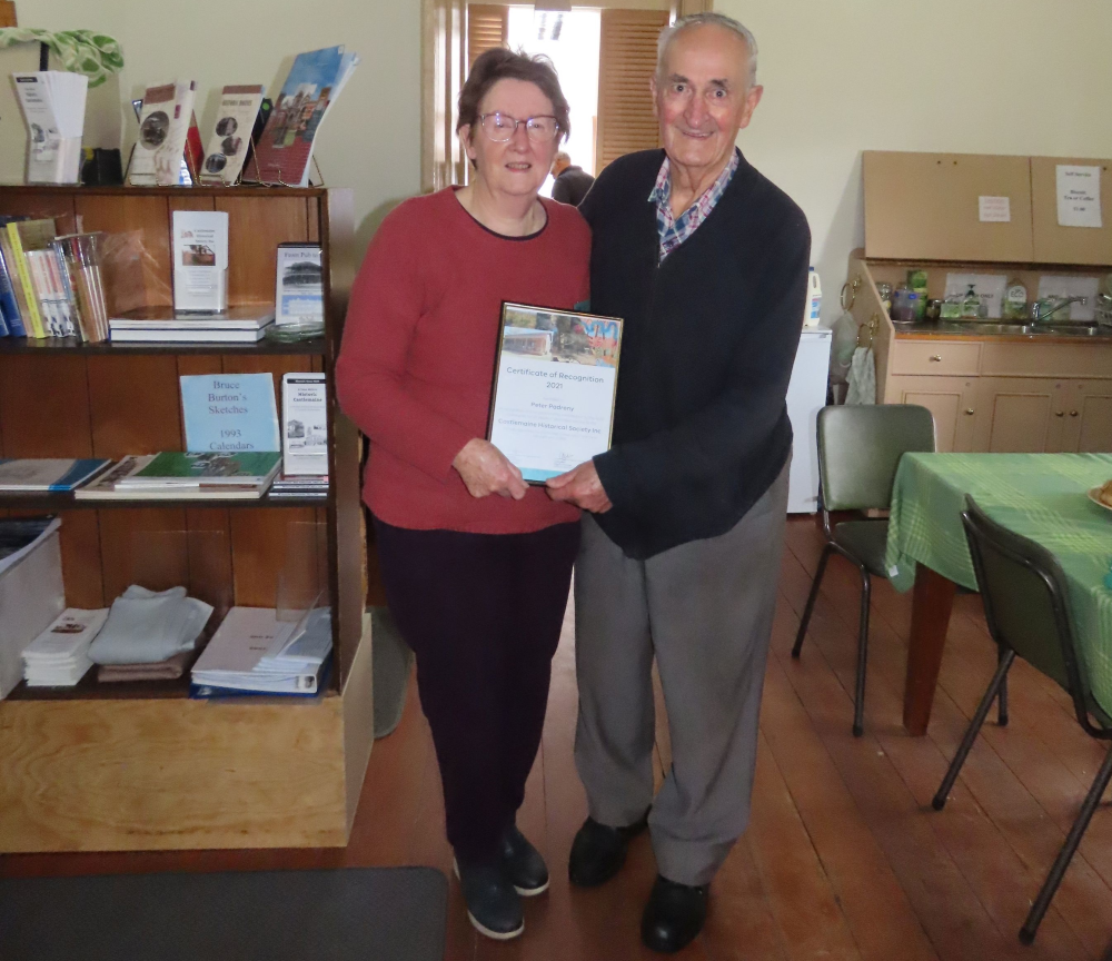 Man and woman holding up a certificate