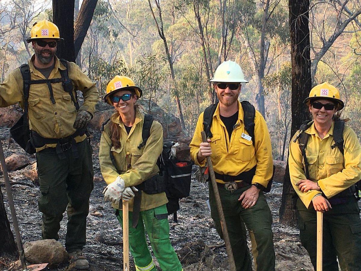 US and FFMVic firefighters standing for photo with shovels