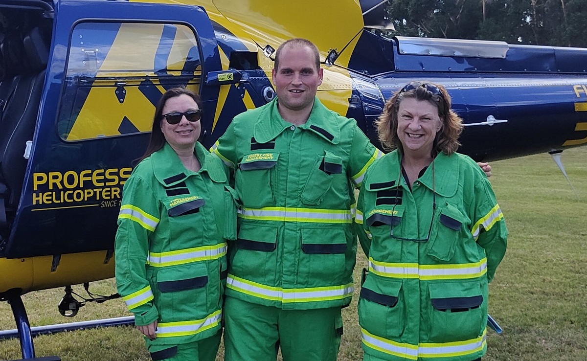 Emergency workers in front of a helicopter.