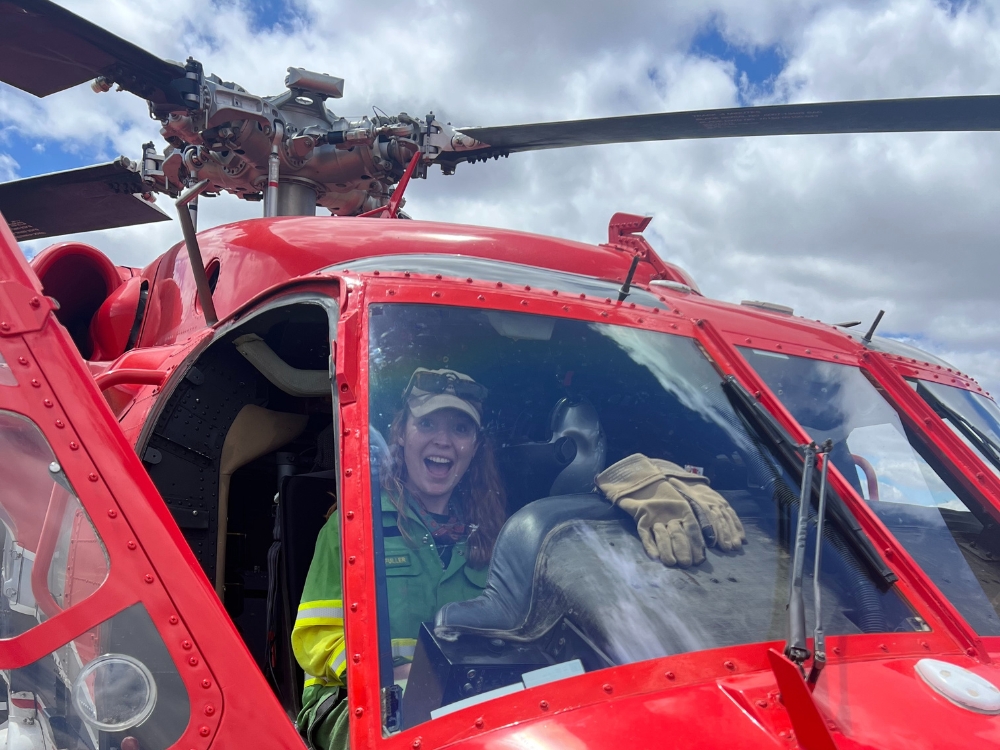 Macy in the cockpit seat. Red helicopter