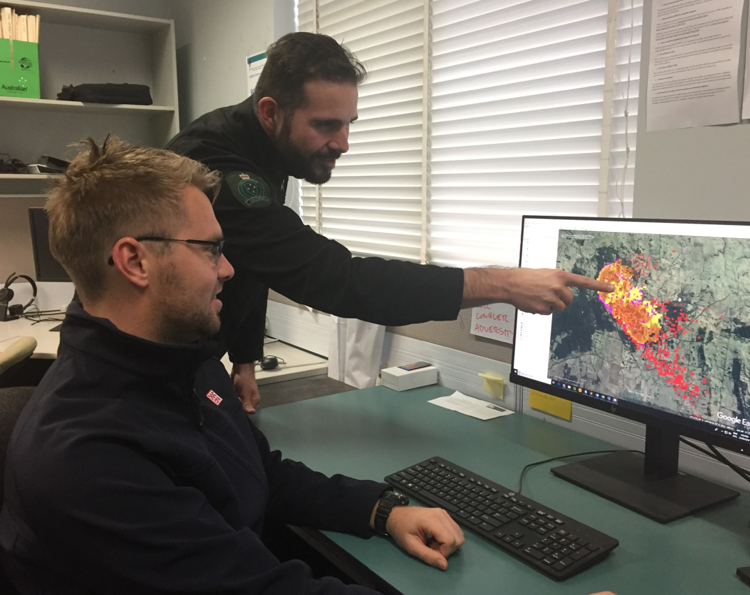 Image showing Team Leader, Bushfire Predictive Services Phillip Brien working with a colleague on bushfire mapping.