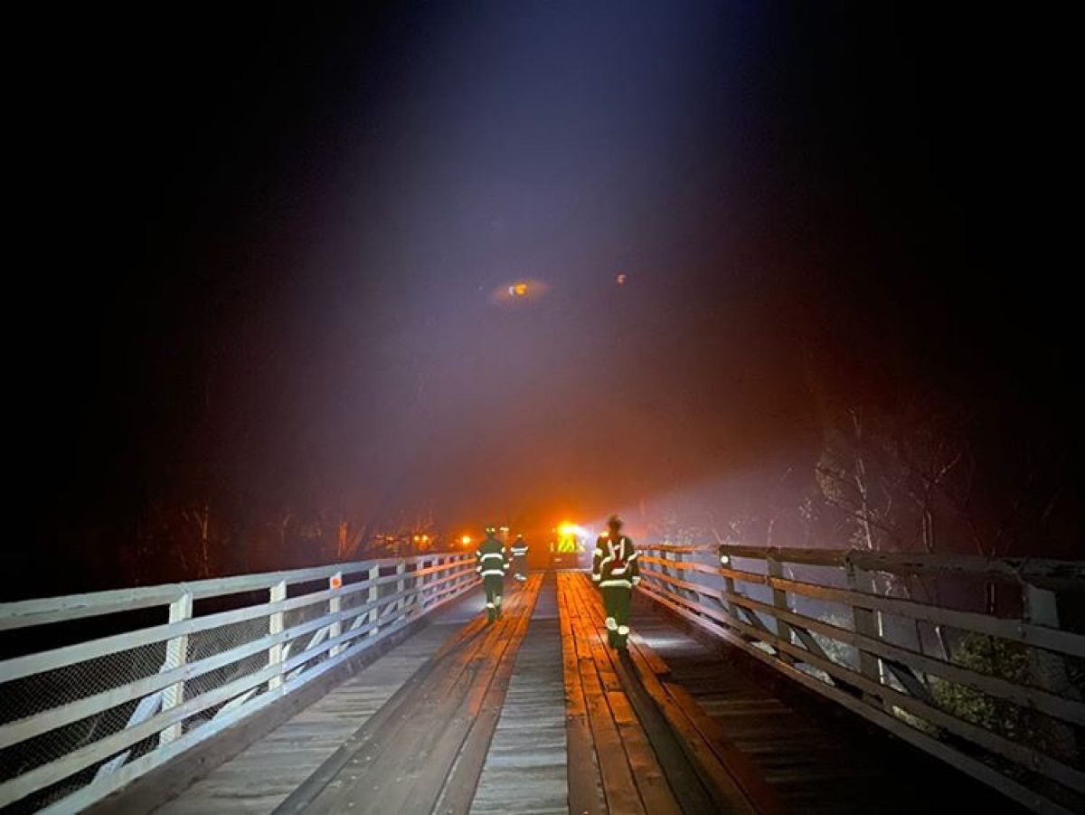 Fire fighters protecting iconic McKillops Bridge in the Bendoc and Bombala area of East Gippsland with fire close by