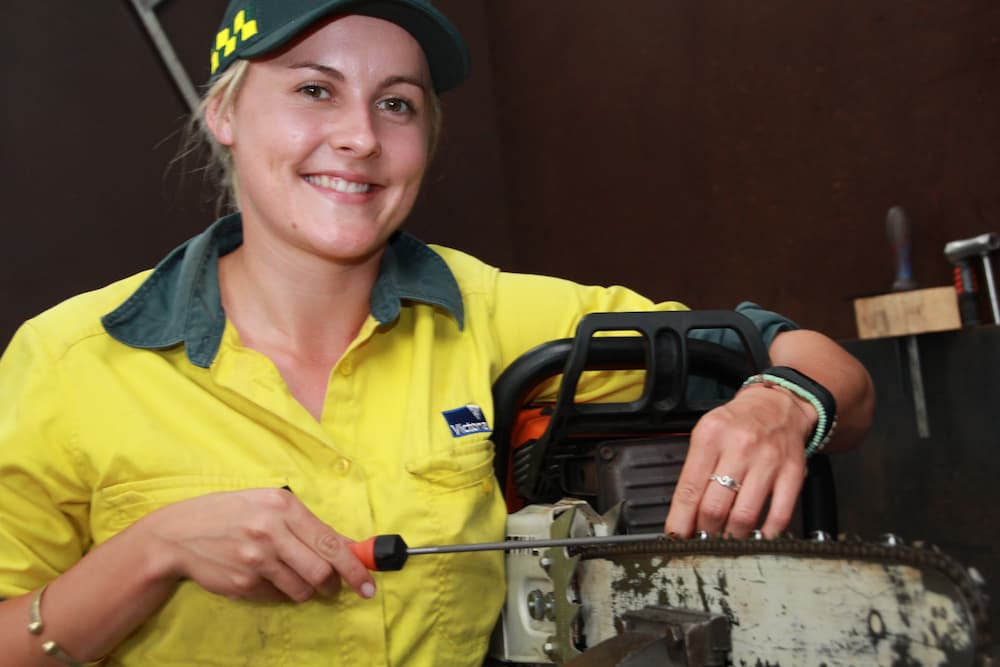Catherine Joyce, firefighter working on chainsaw