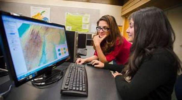  Two people looking at a GIS desktop