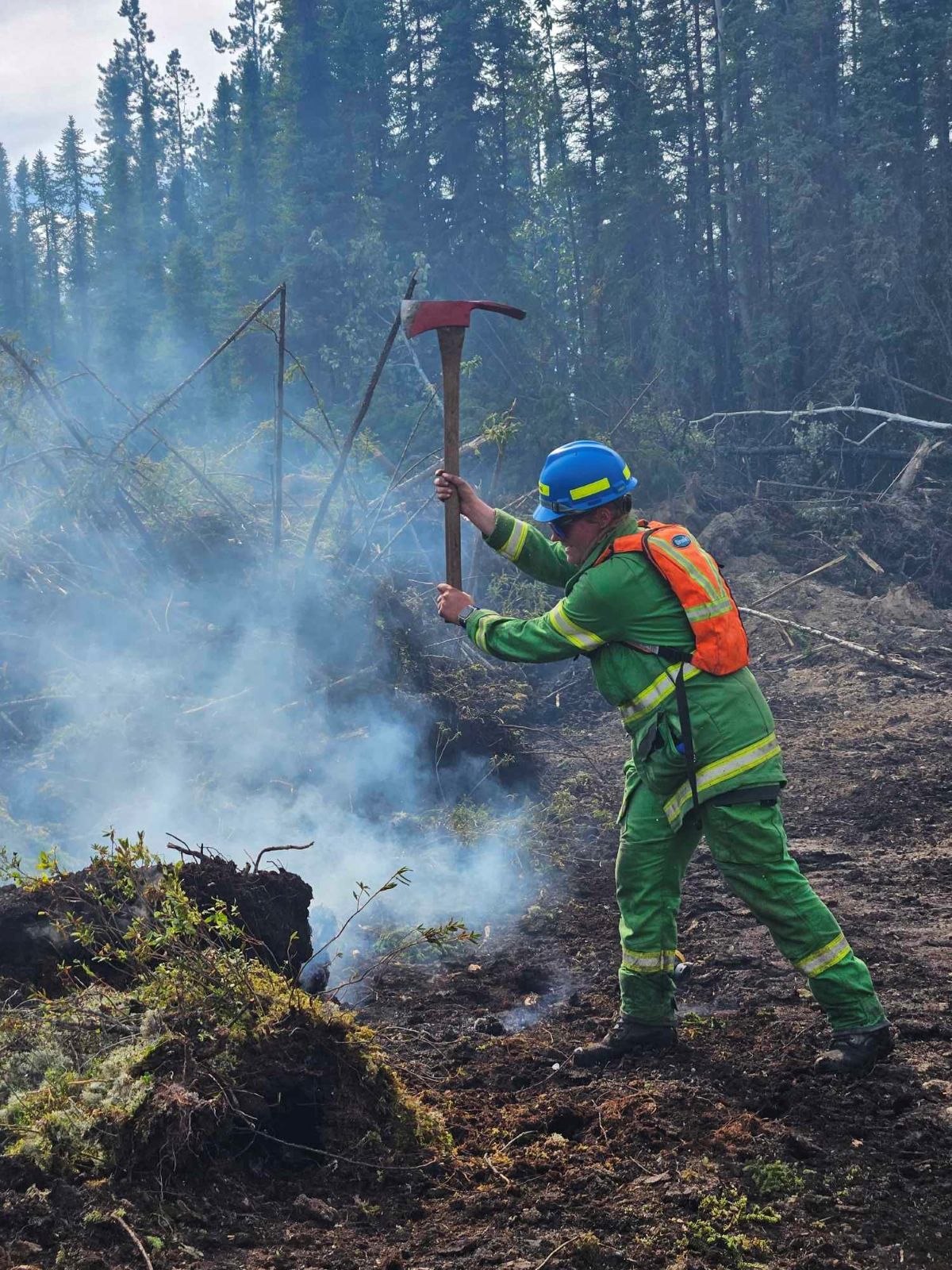Brooke using an axe in a wildfire in Canada