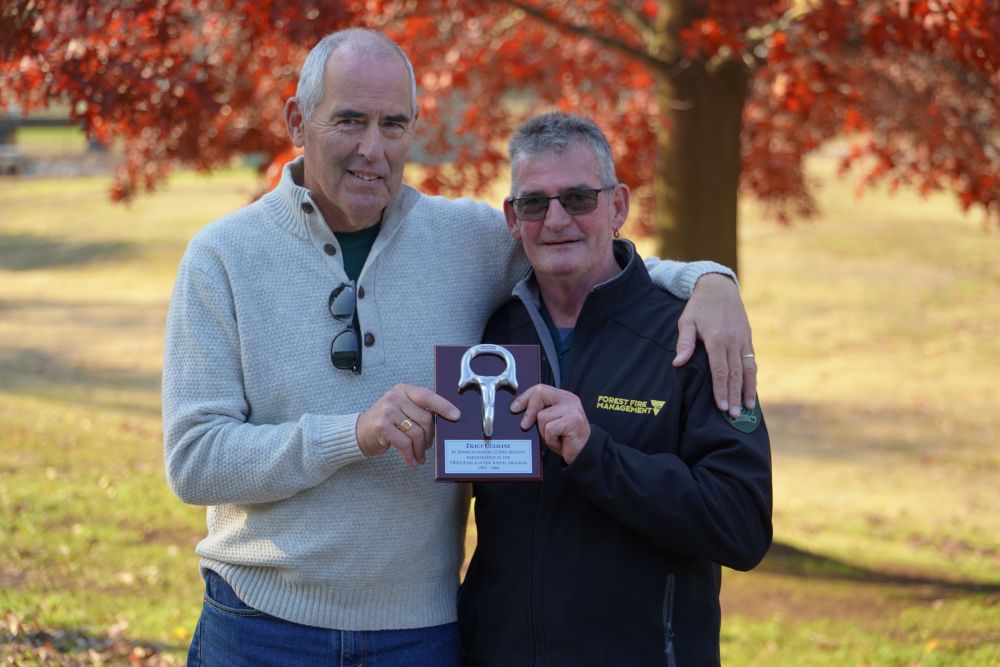 Bryan Rees presenting Tracy with rappel plaque for 12 fire seasons