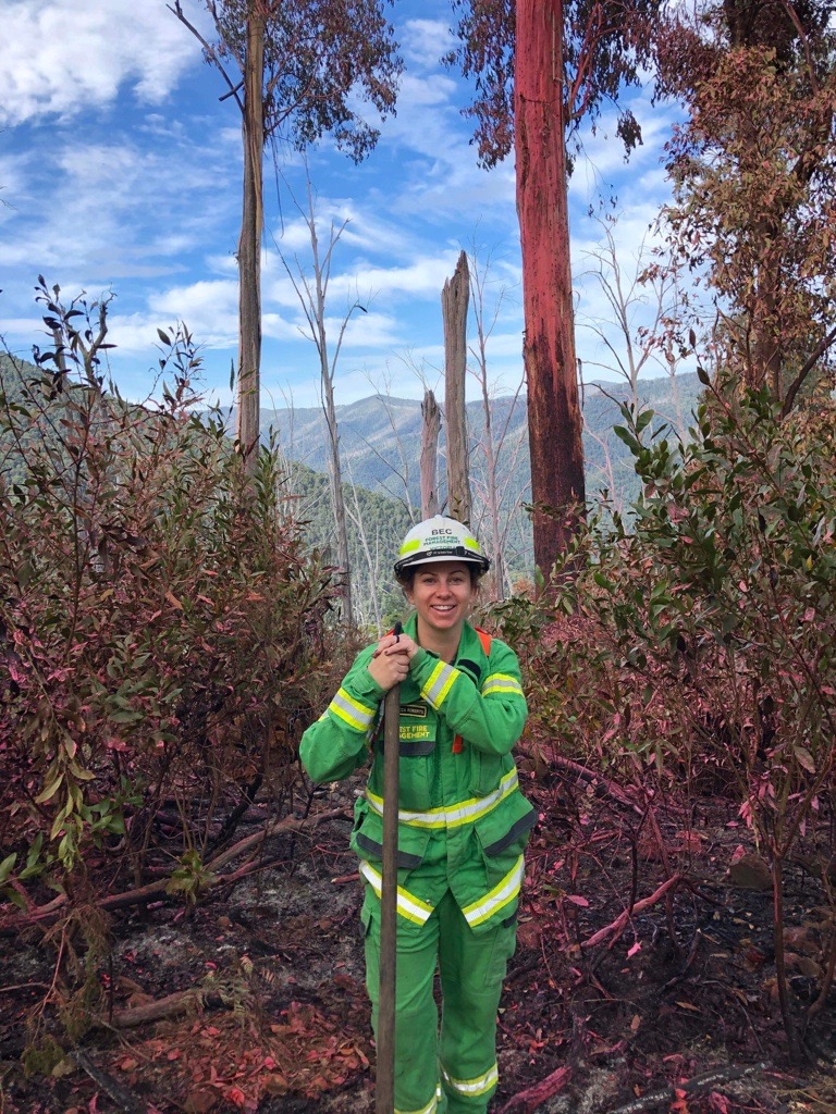 A firefighter in forest setting.